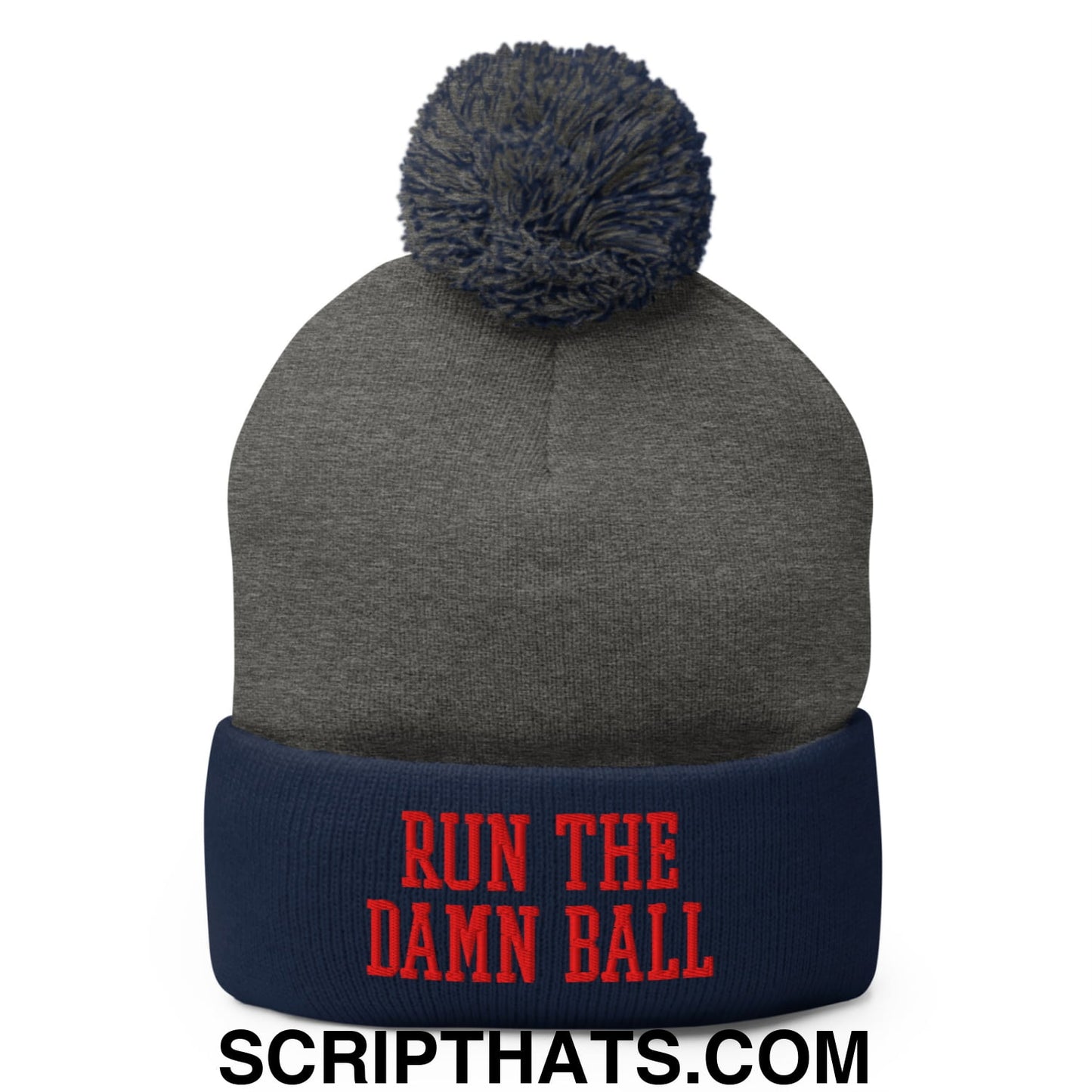 Gray knit beanie with navy blue cuff and pom pom featuring red embroidered text run the damn ball