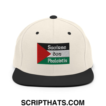 Cream-colored snapback hat with black brim and embroidered palestinian flag patch with saoirse don phalaistin text