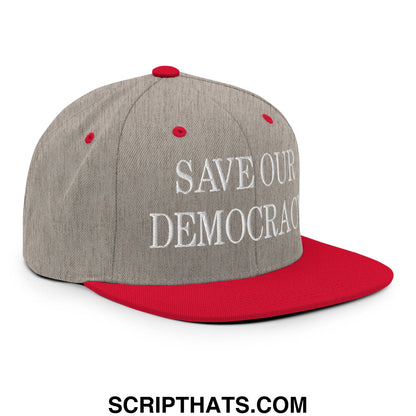 Gray and red snapback hat with white embroidered save our democracy text and flat bill brim design