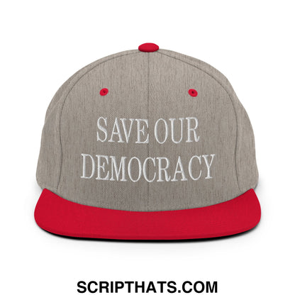 Gray and red snapback hat with white embroidered save our democracy text and flat bill brim