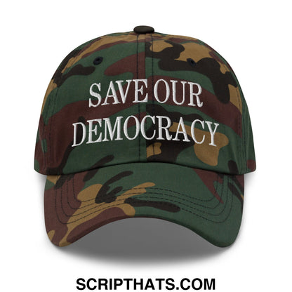 A camouflage unstructured dad hat with save our democracy embroidered in white thread on the front
