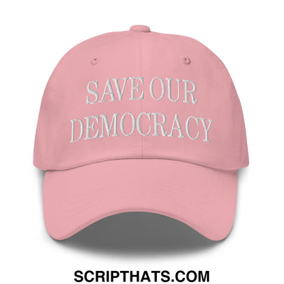 A soft pink embroidered unstructured dad hat with save our democracy text on the front panel