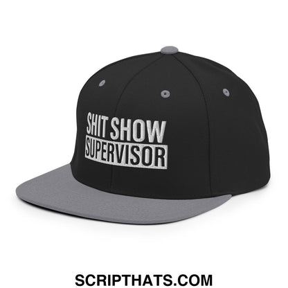 Black and gray snapback hat with shit show supervisor embroidered in white on flat bill brim