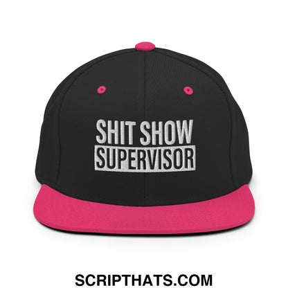 Black snapback hat with vibrant pink brim and button featuring white embroidered shit show supervisor text