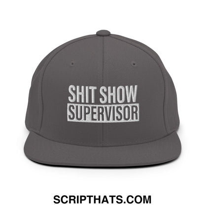 Dark gray snapback hat with white embroidered bold text reading shit show supervisor flat bill brim design