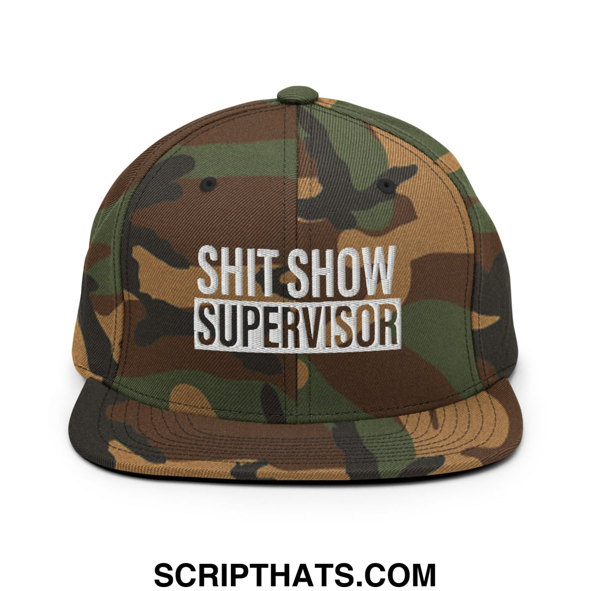 A camouflage snapback hat with shit show supervisor embroidered in white and black flat bill brim design
