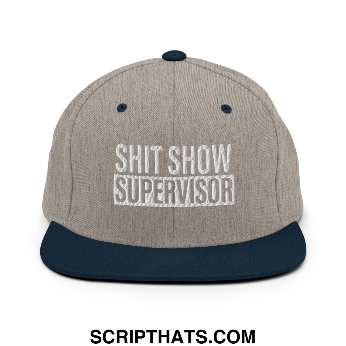 A gray and navy blue snapback hat with shit show supervisor embroidered in white on a flat bill brim