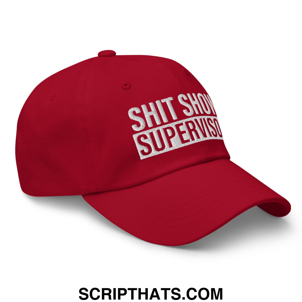 Red unstructured dad hat with white embroidered text reading shit show supervisor in a casual style baseball cap