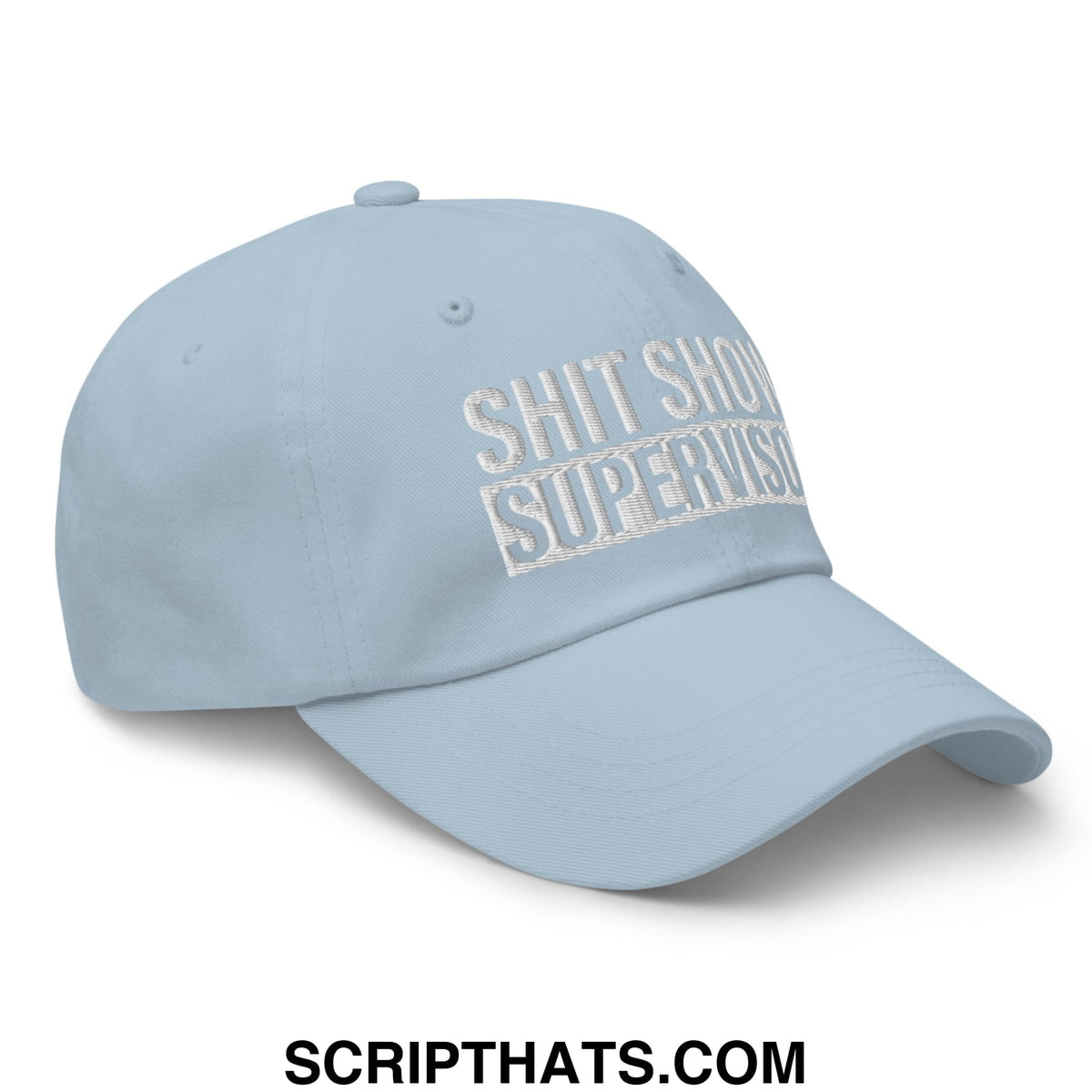 Light blue embroidered unstructured dad hat with white text reading shit show supervisor in a casual style