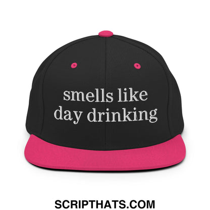 Black snapback cap with vibrant pink brim and button featuring white embroidered text smells like day drinking