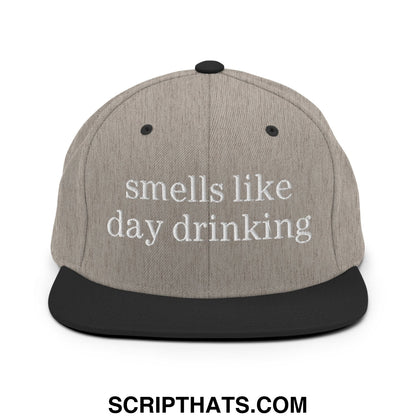 Gray snapback hat with black brim and embroidered white text reading smells like day drinking flat bill design