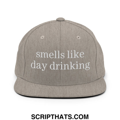 Gray snapback hat with white embroidered text reading smells like day drinking flat bill brim design