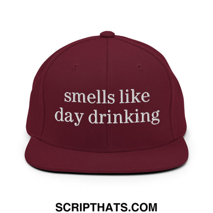 Maroon embroidered flat bill brim snapback hat with white text reads smells like day drinking