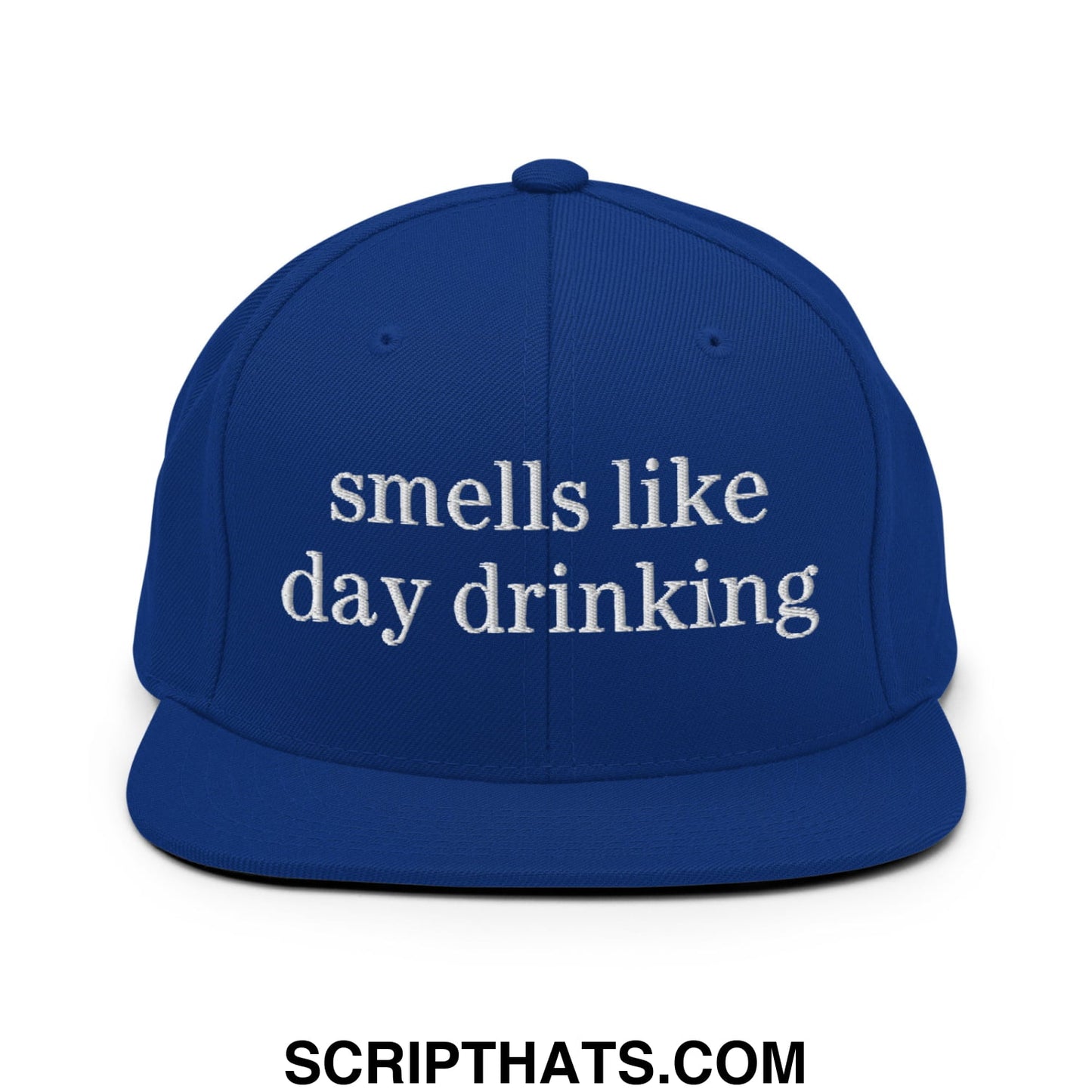 Royal blue snapback cap with white embroidered text smells like day drinking and flat bill brim design
