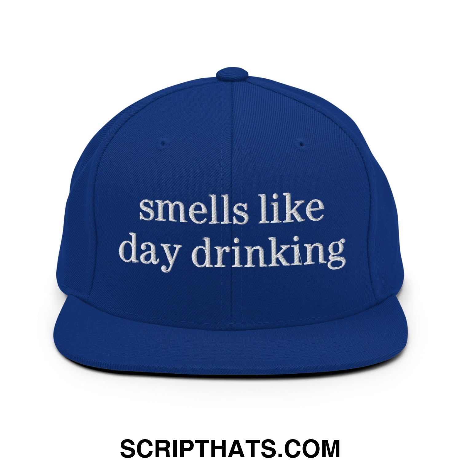 Royal blue snapback cap with white embroidered text smells like day drinking and flat bill brim design