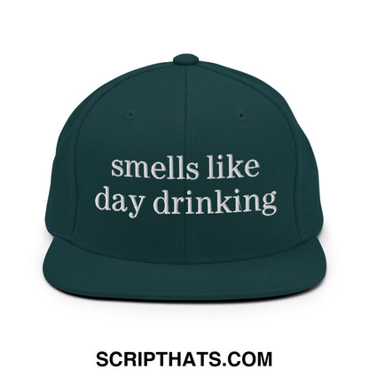 Dark green snapback cap with white embroidered text smells like day drinking on flat bill brim