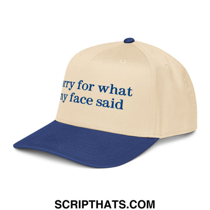 Beige and navy blue baseball snapback hat with dark blue embroidered sorry for what my face said text