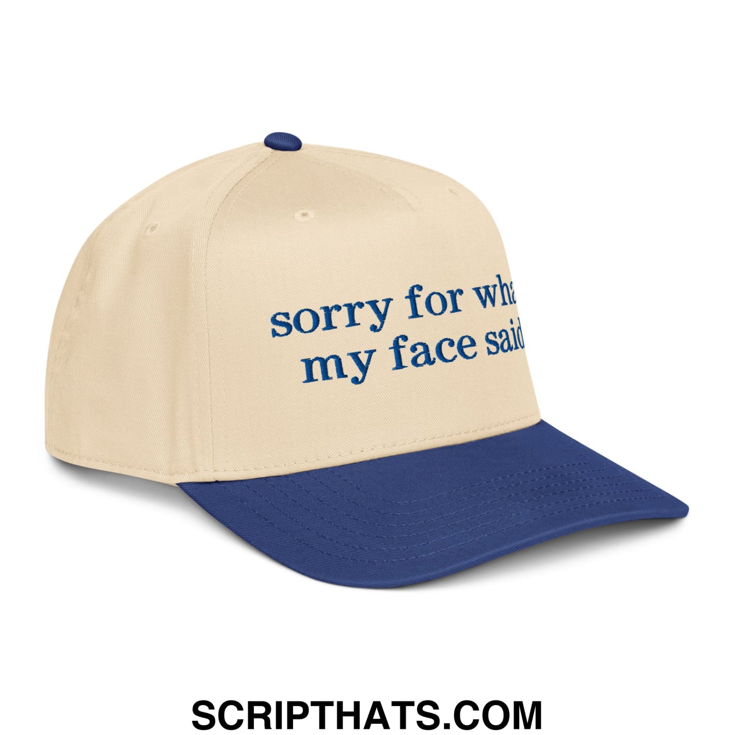 Beige and navy blue embroidered baseball snapback hat with sorry for what my face said text in dark blue script font