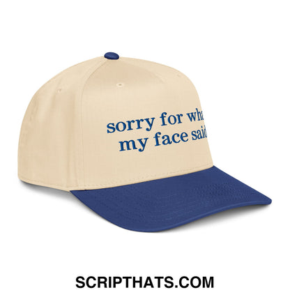 Beige and navy blue embroidered baseball snapback hat with sorry for what my face said text in dark blue script font