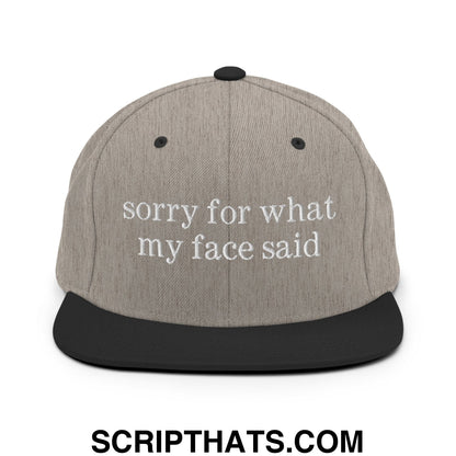 Gray and black snapback cap with white embroidered sorry for what my face said text on flat bill brim