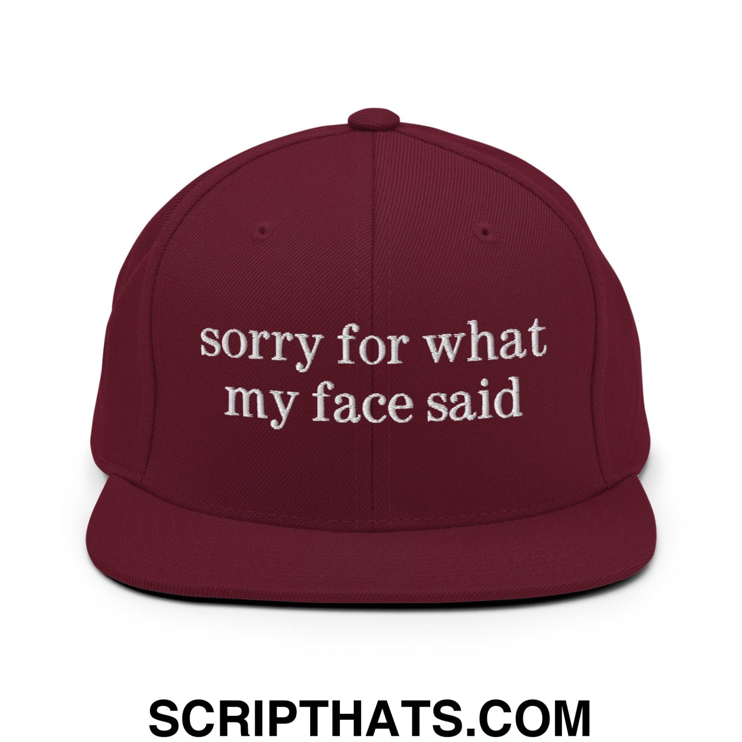 Maroon snapback hat with white embroidered sorry for what my face said text and flat bill brim design