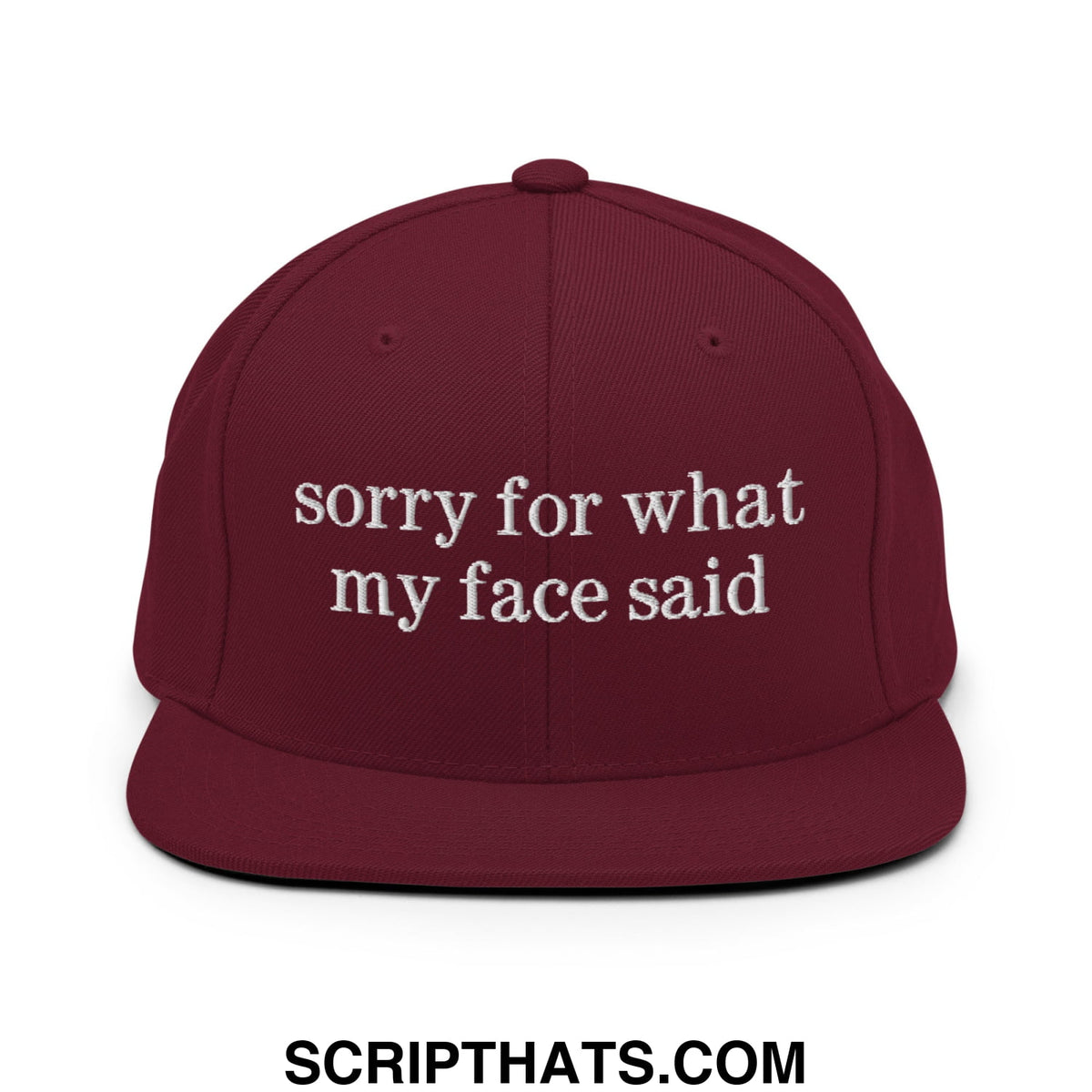 Maroon snapback hat with white embroidered sorry for what my face said text and flat bill brim design