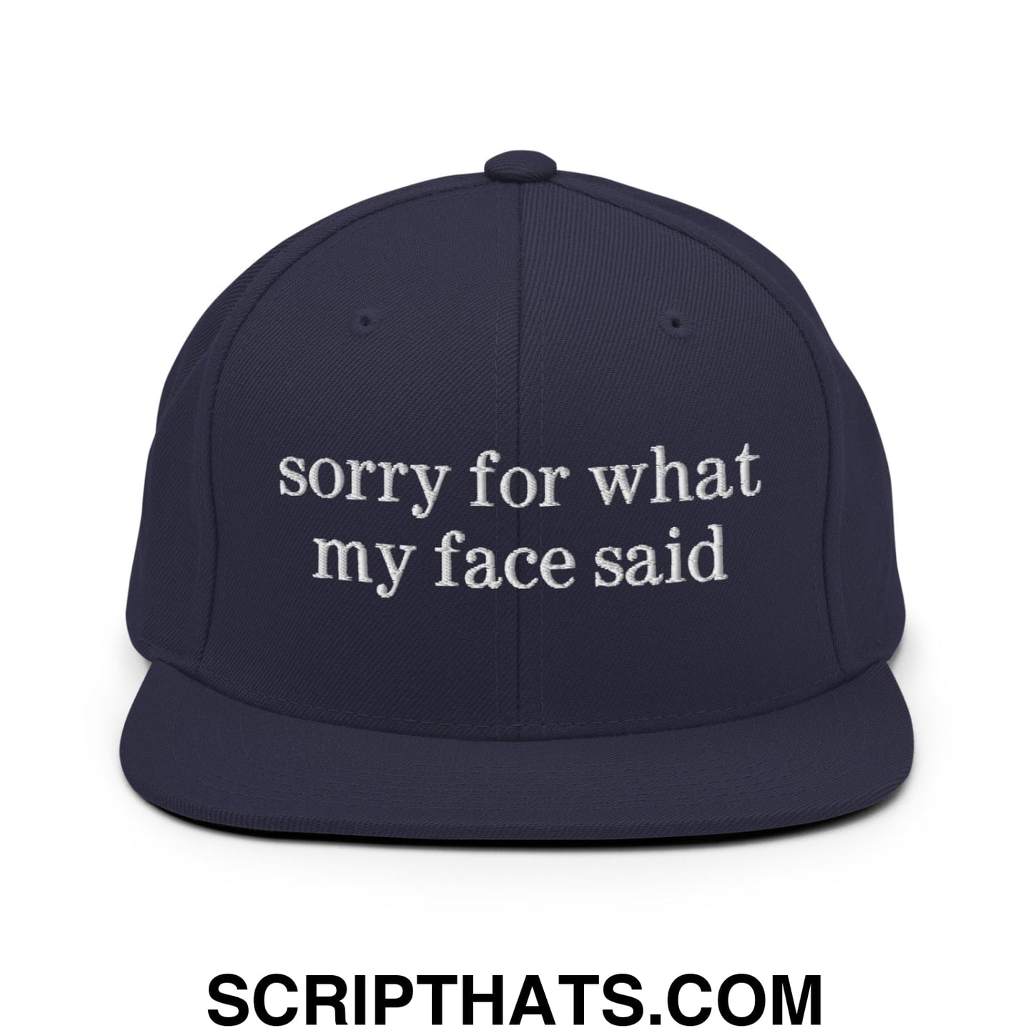 Navy blue snapback hat with white embroidered sorry for what my face said text and flat bill brim design