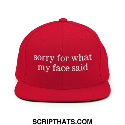 Red snapback hat with white embroidered sorry for what my face said text and flat bill brim design