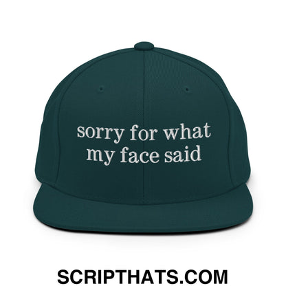 Dark green snapback hat with white embroidered sorry for what my face said text and flat bill brim design