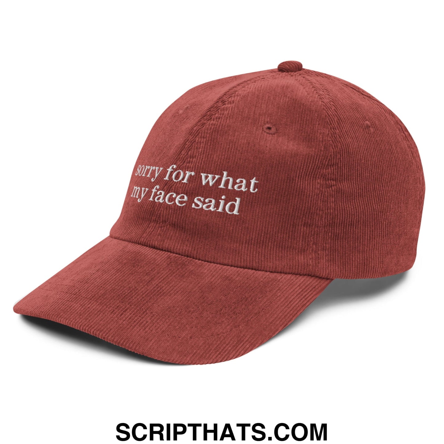 A rust-colored unstructured corduroy dad hat with white embroidered text sorry for what my face said