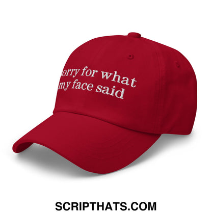 Red embroidered unstructured dad hat with white sorry for what my face said text on the front