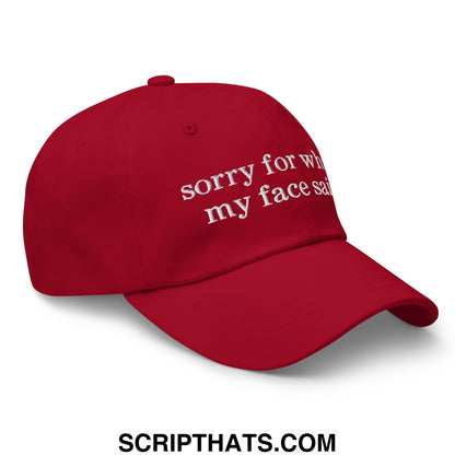 Red embroidered unstructured dad hat with white sorry for what my face said text on front panel