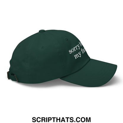 Dark green unstructured dad hat with white embroidered sorry for my face text in casual streetwear style