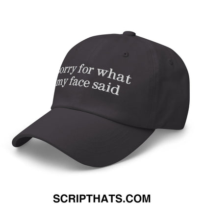 Black unstructured dad hat with white embroidered text saying sorry for what my face said
