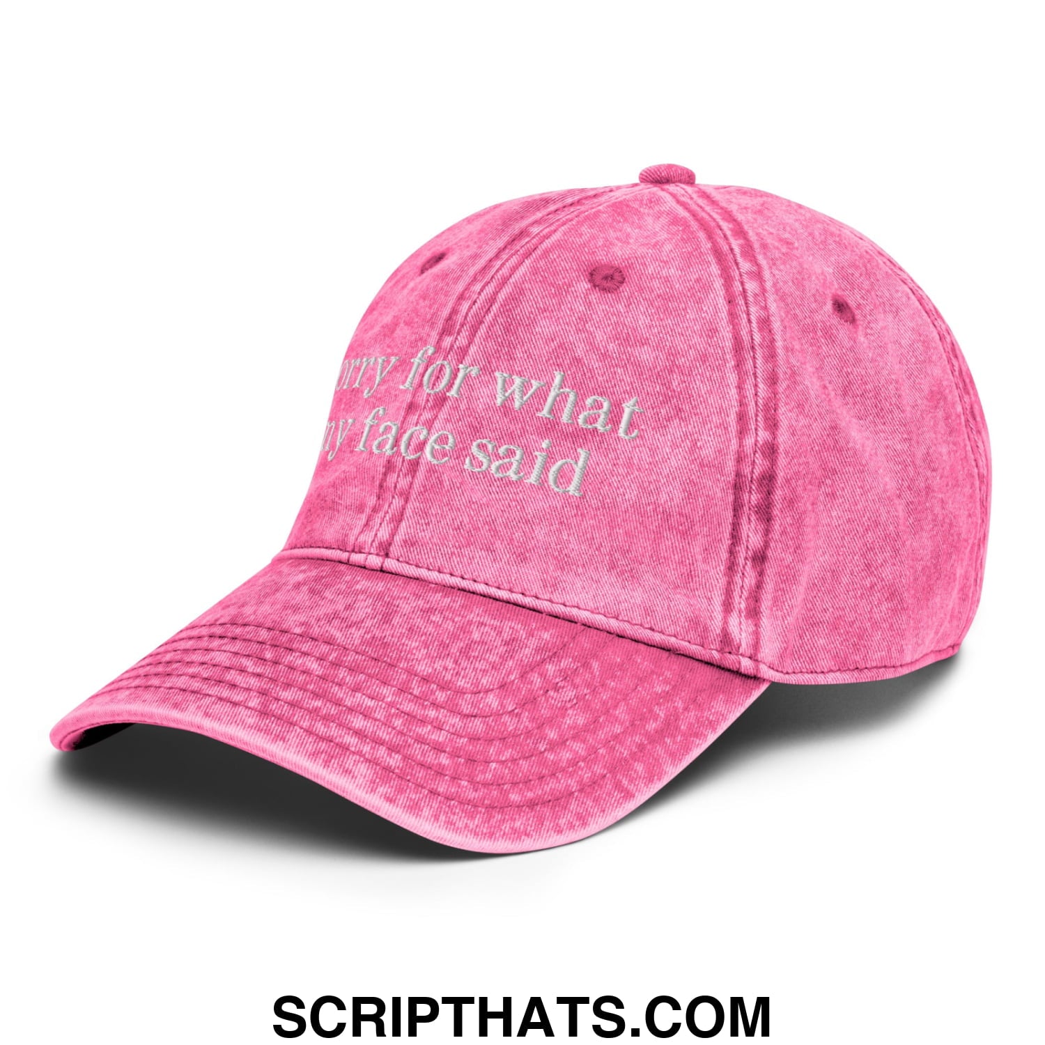 A faded pink unstructured denim dad hat with white embroidered text sorry for what my face said on the front