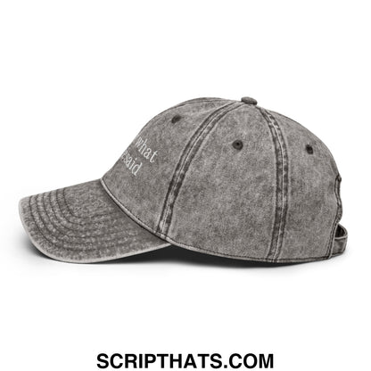 A faded gray denim dad hat with what he said embroidered in white thread on the front unstructured design