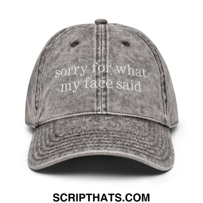 A faded gray denim dad hat with white embroidered sorry for what my face said text unstructured design