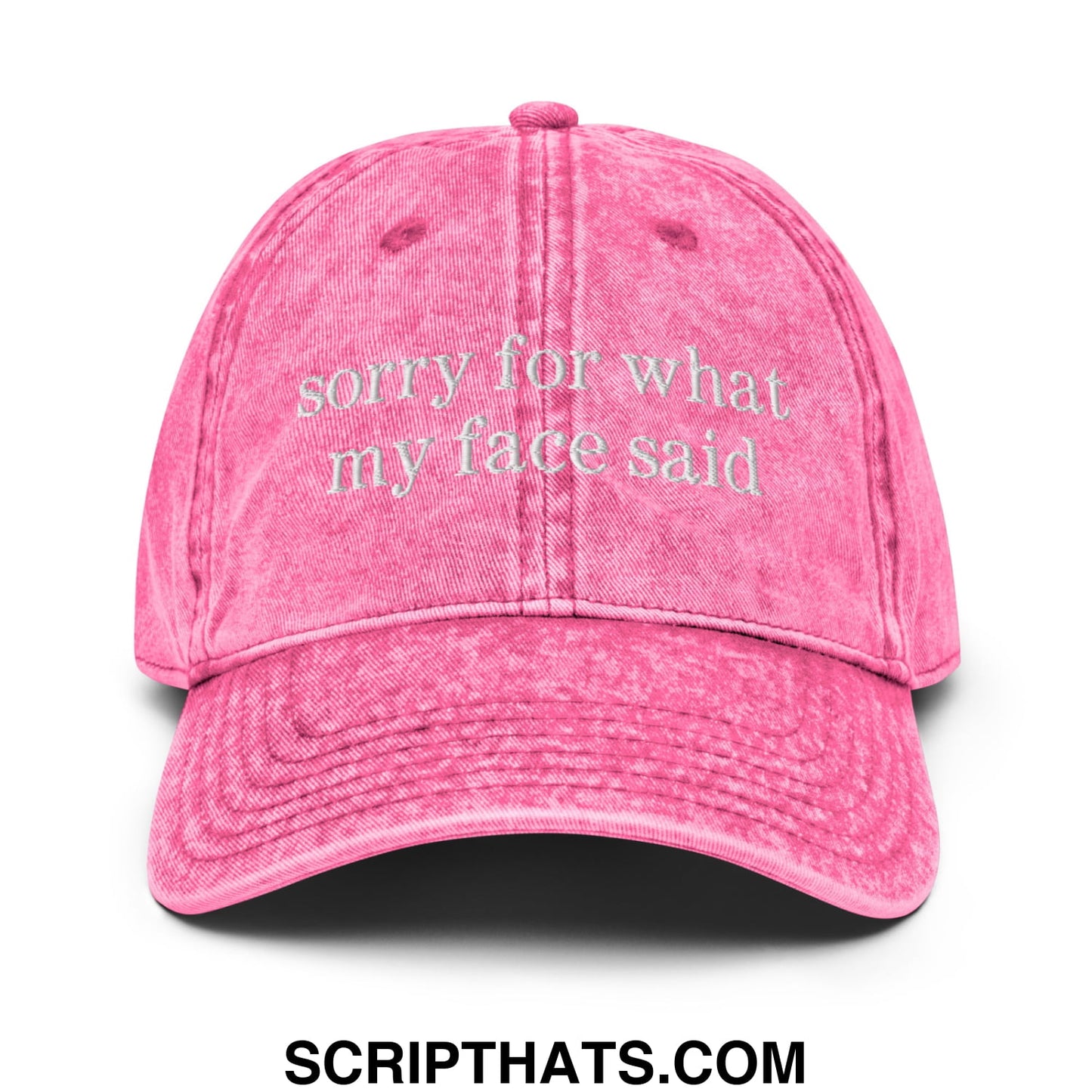 A faded pink denim unstructured dad hat embroidered with sorry for what my face said text on the front