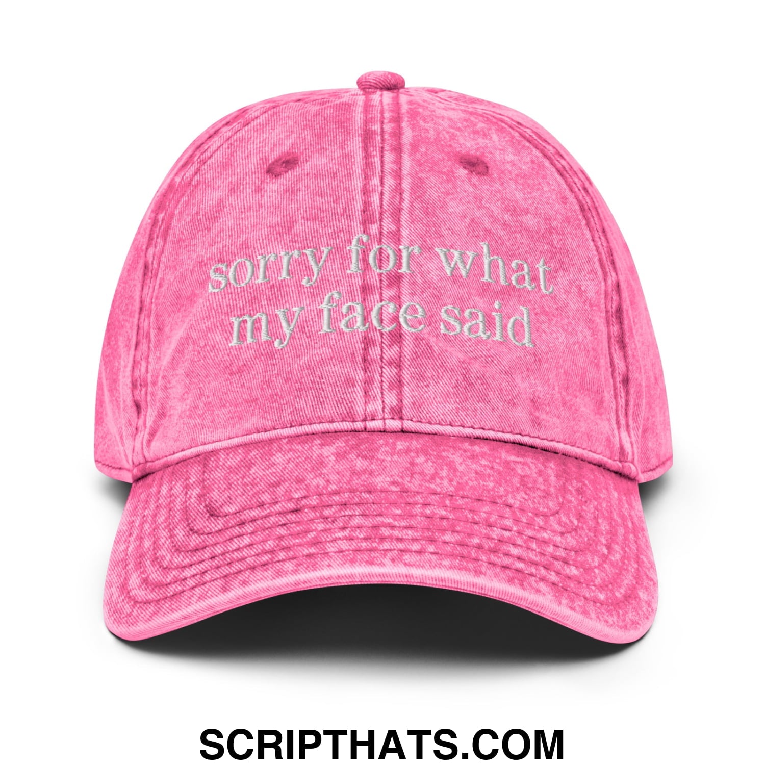 A faded pink denim unstructured dad hat embroidered with sorry for what my face said text on the front
