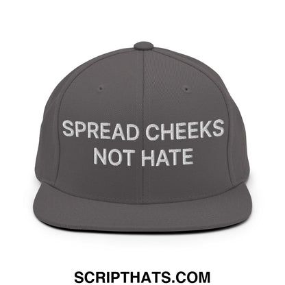 A dark gray snapback hat with a flat bill and white embroidered spread cheeks not hate text on the front