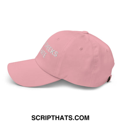 A soft pink unstructured dad hat embroidered with cheeks in silver thread titled spread cheeks not hate