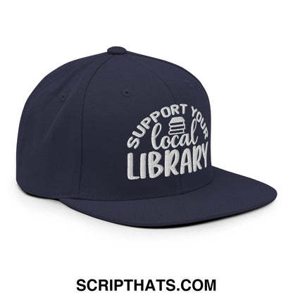 Navy blue snapback hat with white embroidered support your local library text and books stack icon on flat bill brim