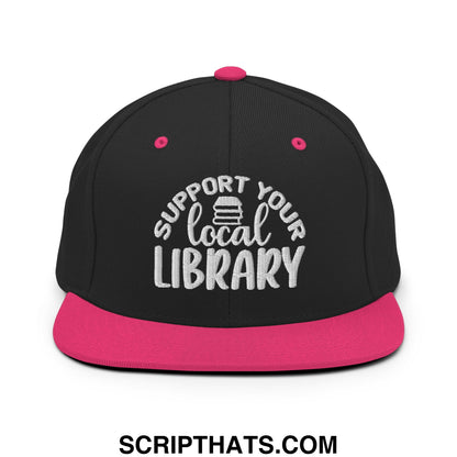 Black and pink snapback hat with white embroidered support your local library text and stack of books graphic