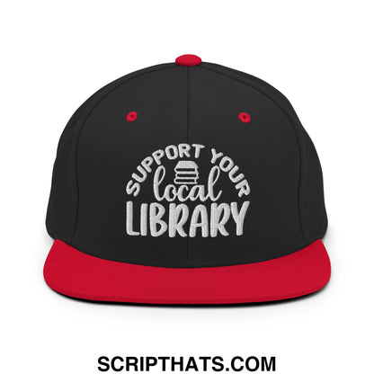 Black and red snapback hat with white embroidered support your local library text and stack of books graphic