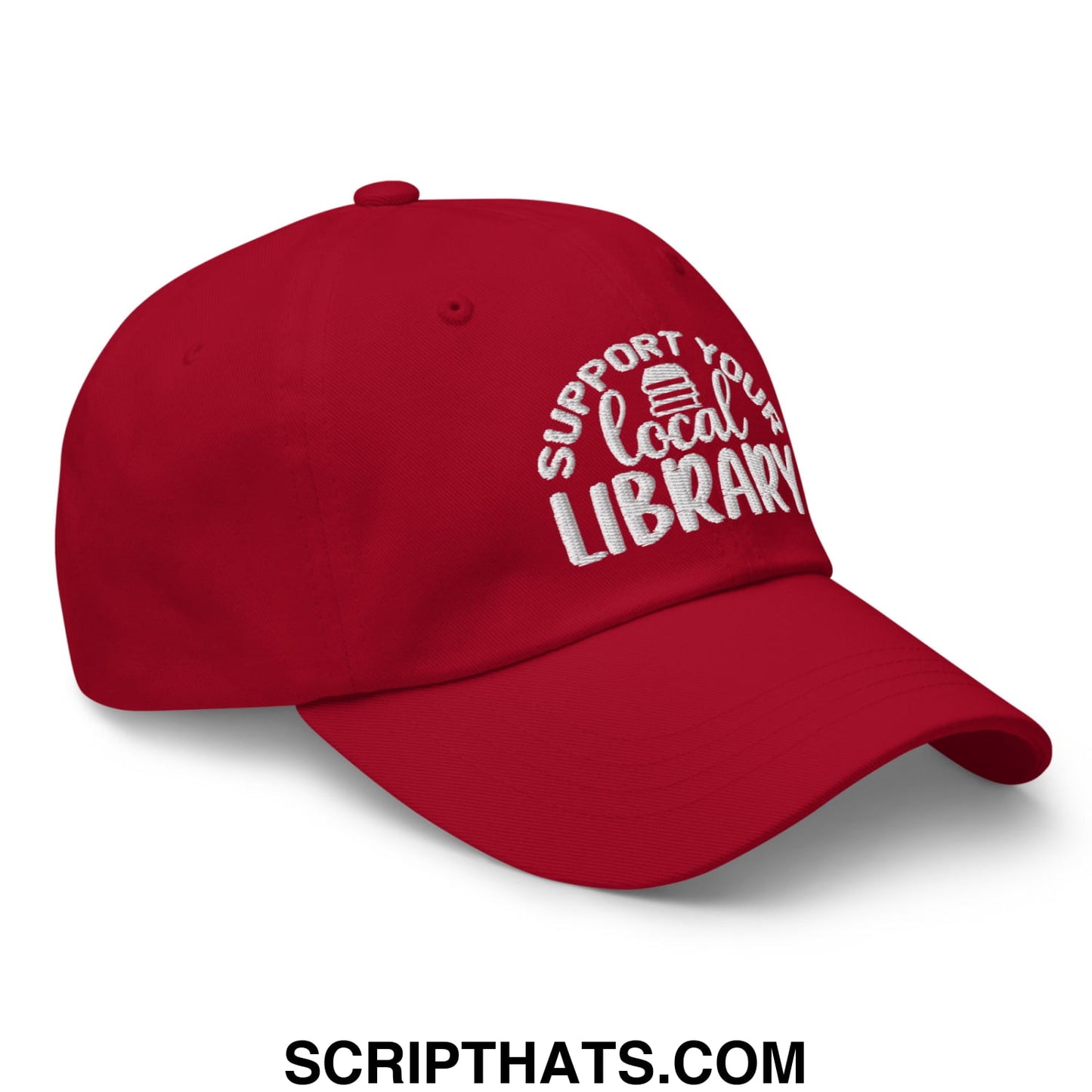 Red embroidered unstructured dad hat with support your local library text and small book icon for casual wear