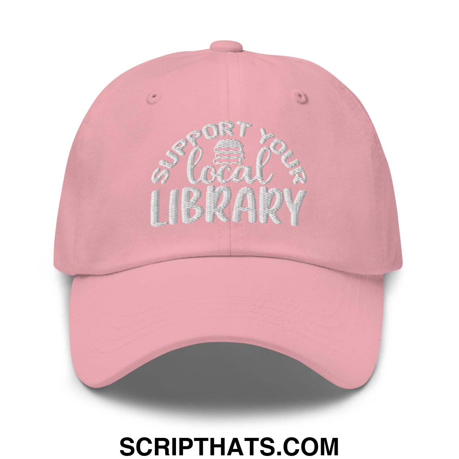 A soft pink embroidered unstructured dad hat with white support your local library text and a stack of books icon