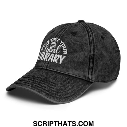 Black distressed denim dad hat with white embroidered support your local library text and book icon on front