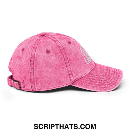 A faded pink unstructured denim dad hat with curved brim and white embroidered support your local library text on the side
