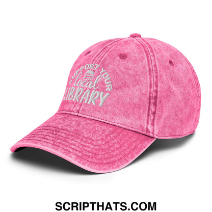 A faded pink unstructured denim dad hat with white embroidery reading support your local library