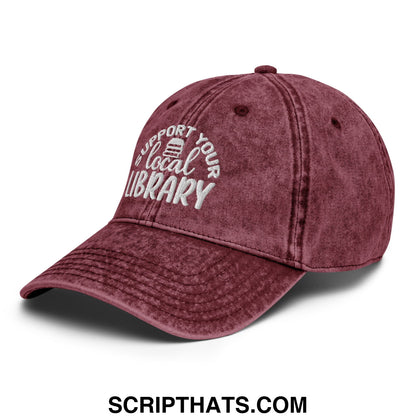 Maroon distressed cotton baseball cap with white embroidered support your local library text and small book icon